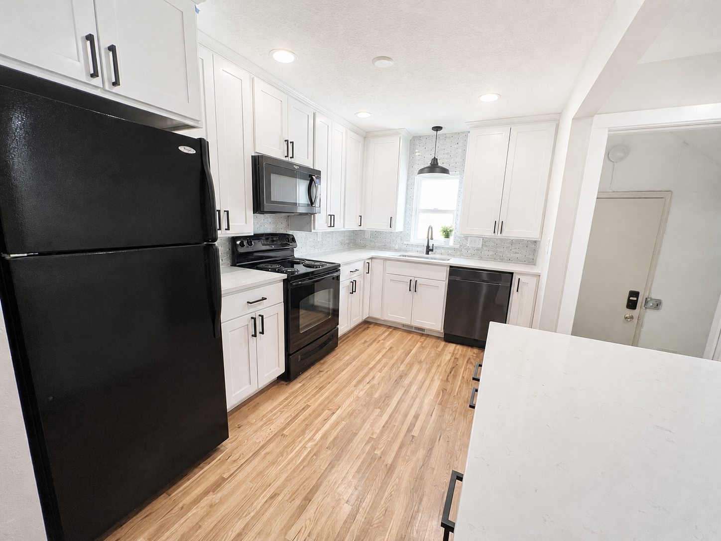 Wide view of the updated lower-home kitchen