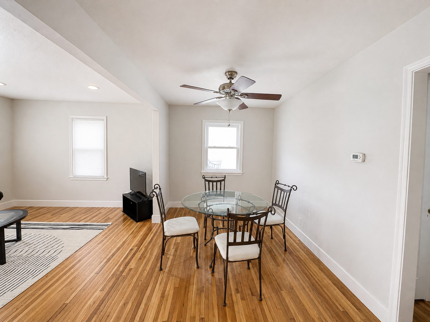 Lower-home dining table beneath a ceiling fan