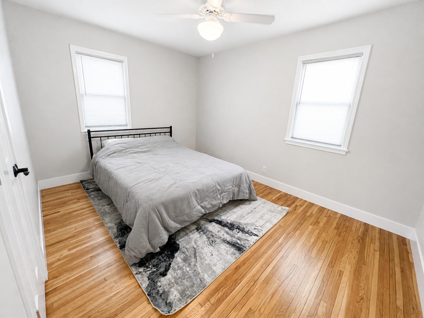 First lower-home queen bedroom with two windows