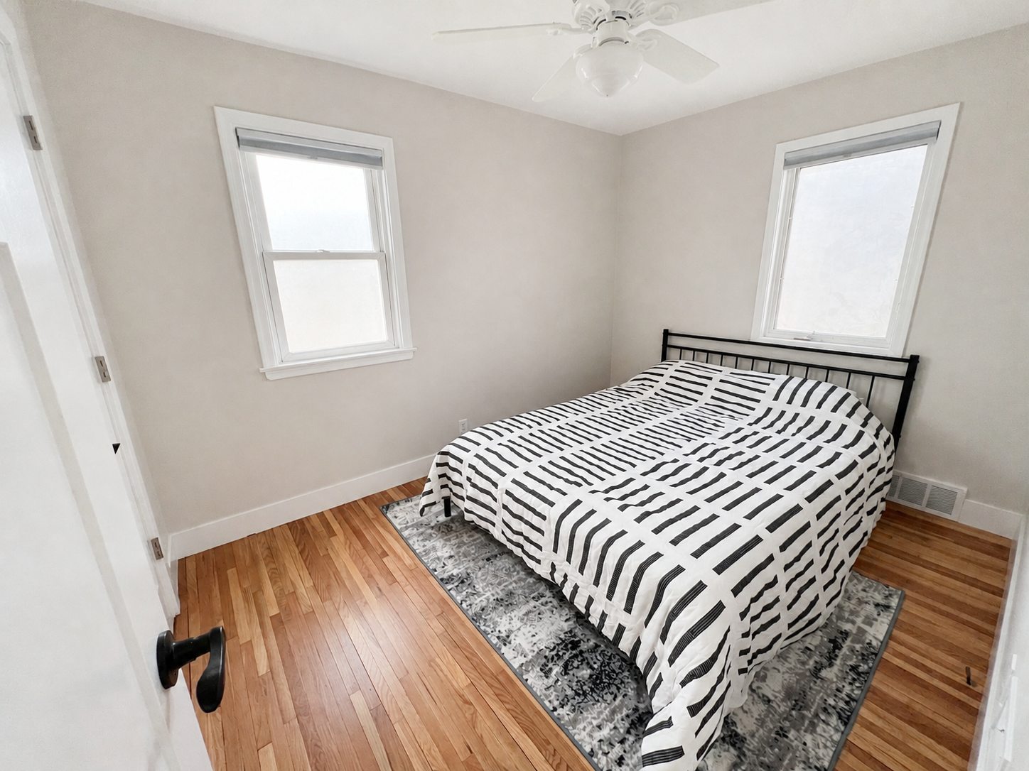 Second lower-home queen bedroom with hardwood floors
