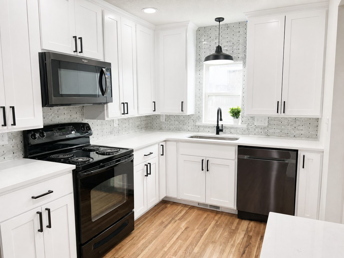 White cabinetry and appliances in the lower-home kitchen