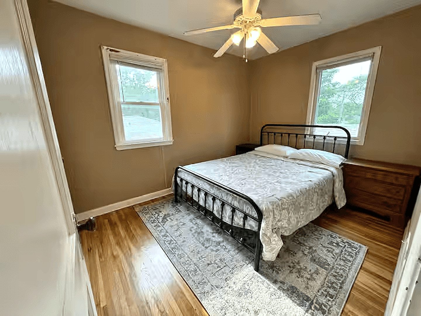 First upper-home queen bedroom with an iron bed frame